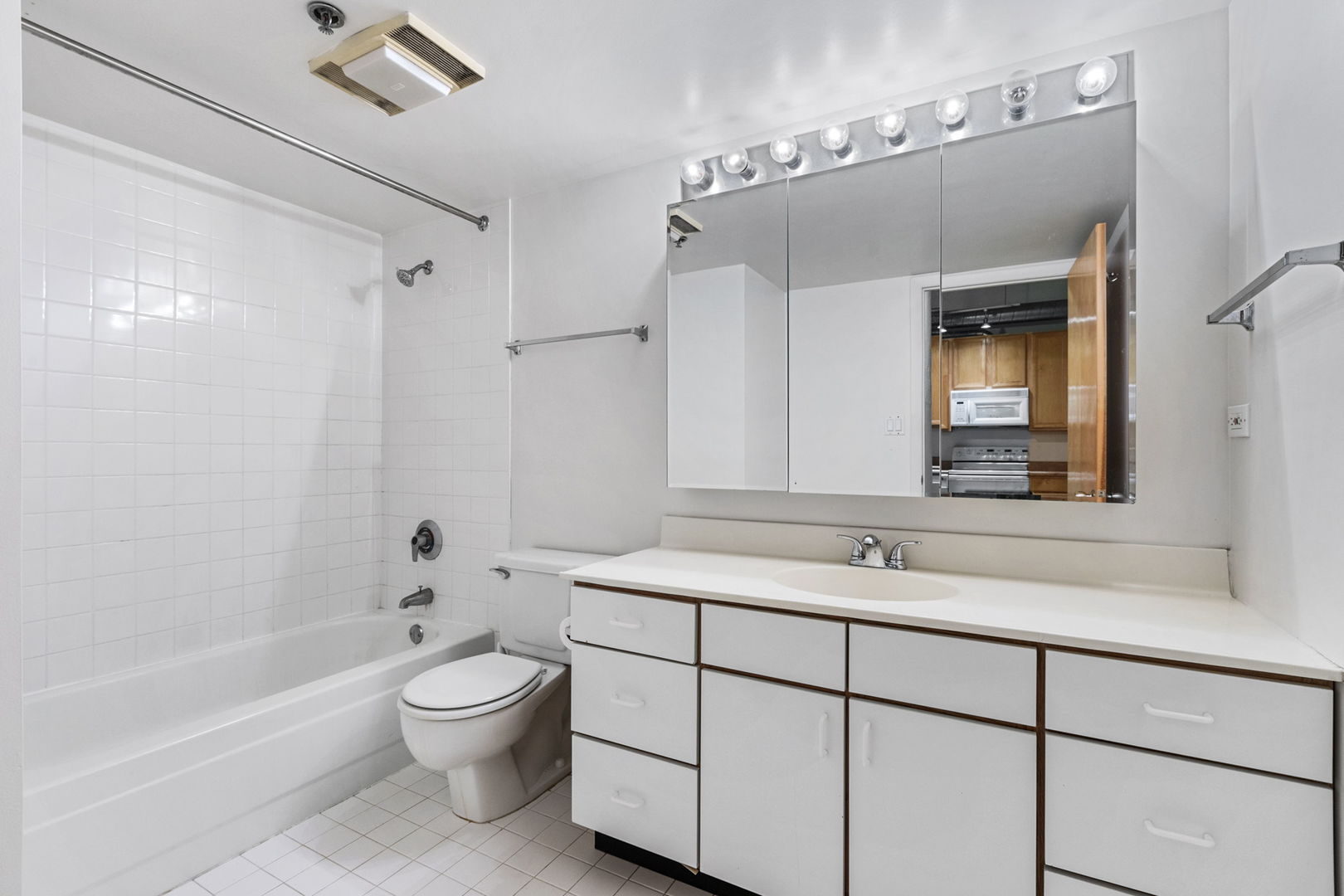 801 South Wells Street, Unit 808 Chicago, IL 60607 - Photo 14 of 15 a bathroom with a sink toilet tub and vanity