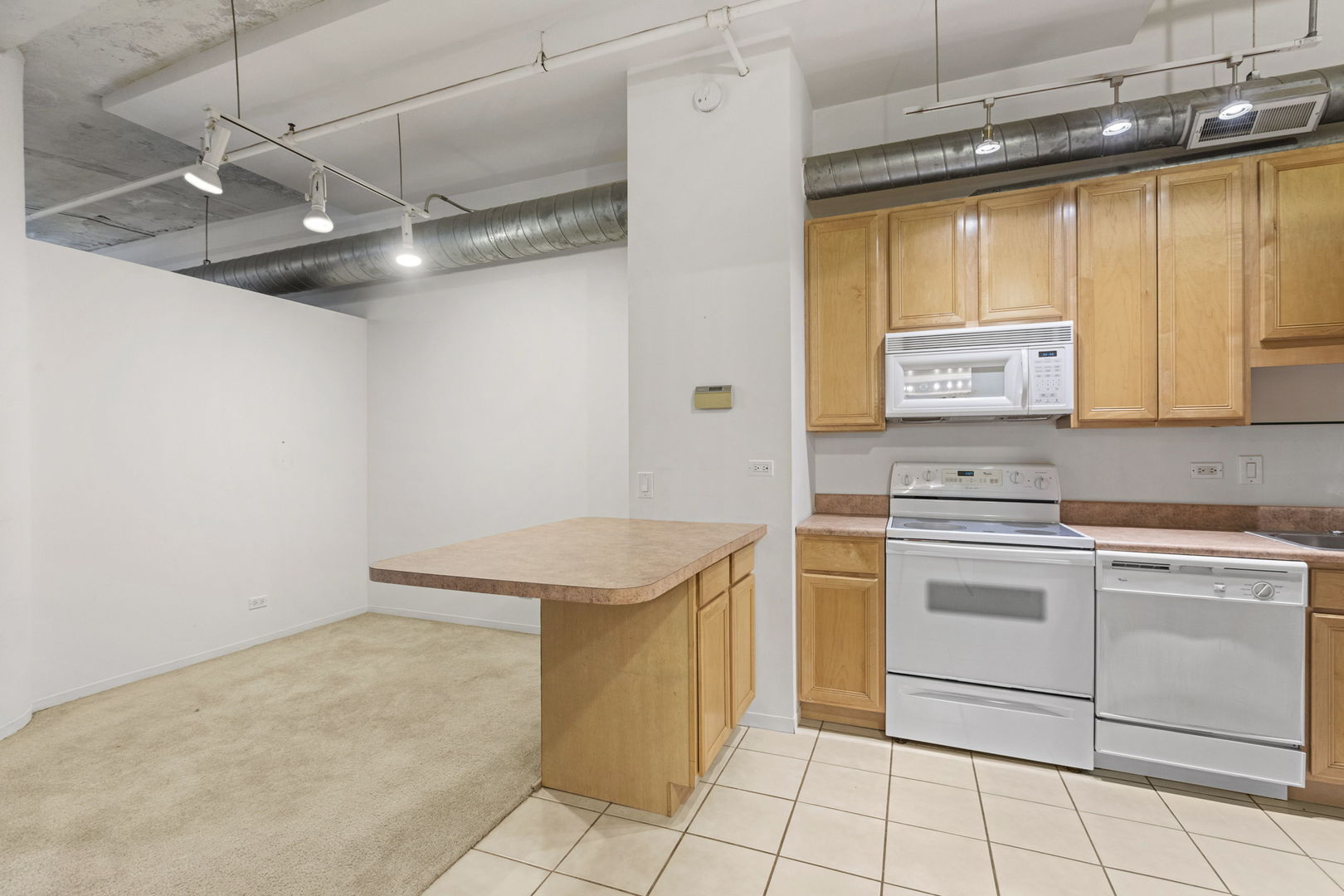 801 South Wells Street, Unit 808 Chicago, IL 60607 - Photo 10 of 15 a kitchen with a stove a sink and a refrigerator