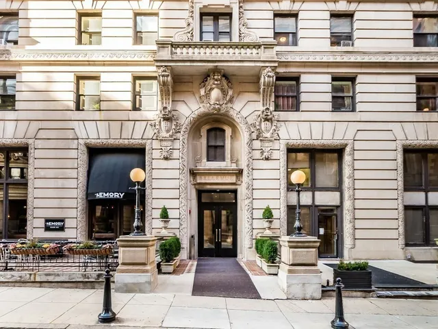 a front view of a building with outdoor seating