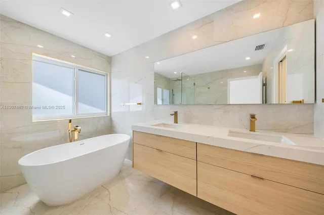 a large white bathroom with a large tub shower and sink