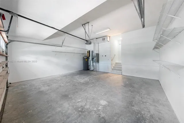 a large white kitchen with a large window