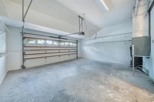 a living room with stainless steel appliances kitchen island sink and cabinets