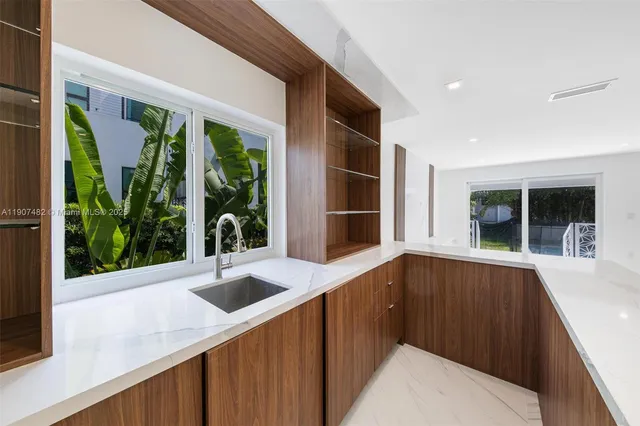 a view of kitchen and hall with wooden floor