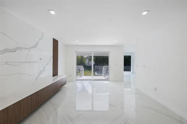 a kitchen with stainless steel appliances a sink stove and cabinets