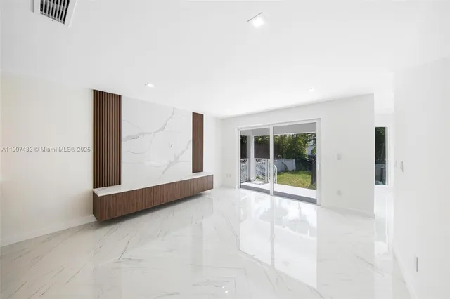 a large kitchen with kitchen island a sink a counter top space stainless steel appliances and cabinets