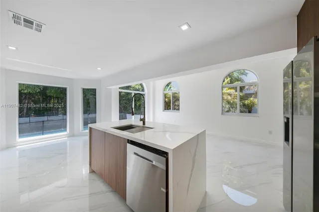 a view of backyard with large windows and balcony