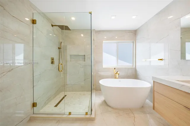 a bathroom with a white tub shower and mirror