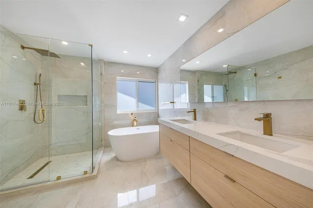 a bathroom with a bathtub a sink and a window