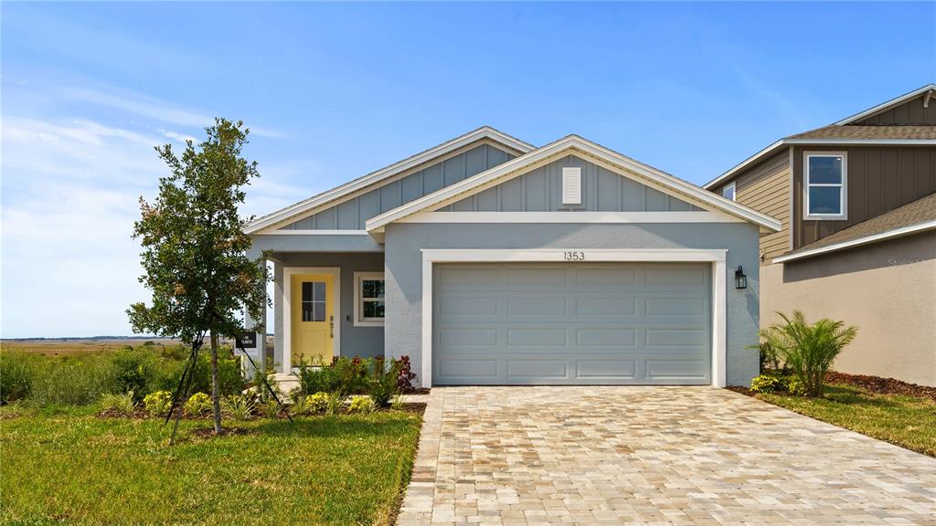 1353 June Lake Loop Haines City, FL 33844 - Photo 1 of 44 a front view of a house with a yard and garage