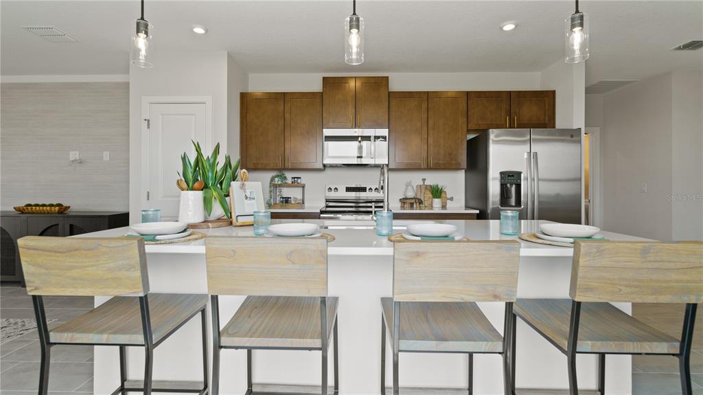 1353 June Lake Loop Haines City, FL 33844 - Photo 16 of 44 a kitchen with kitchen island granite countertop counter top space cabinets and stainless steel appliances