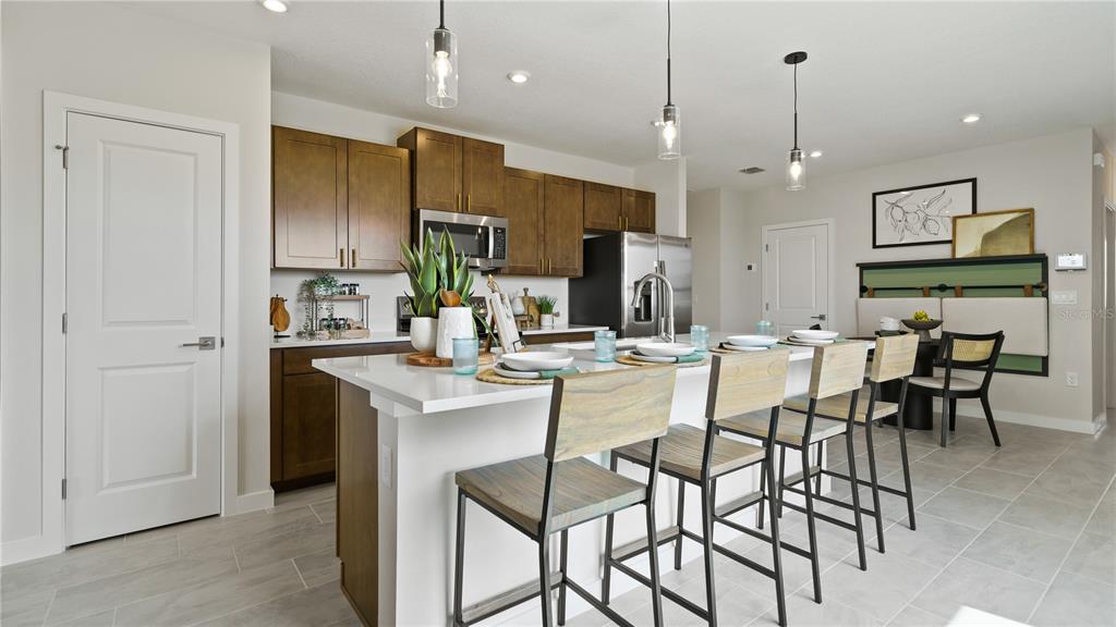 1353 June Lake Loop Haines City, FL 33844 - Photo 18 of 44 a large kitchen with a table and chairs