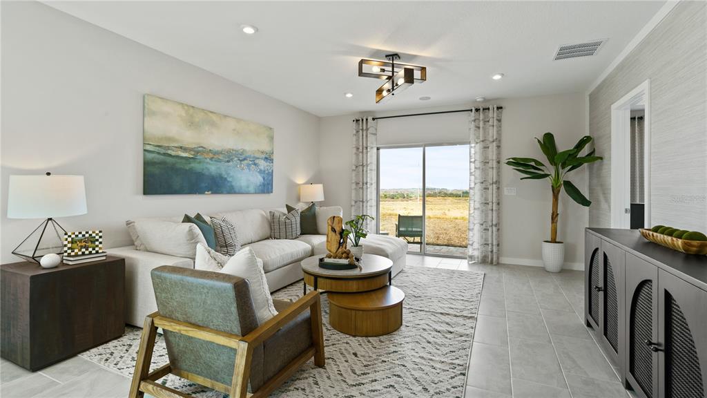 1353 June Lake Loop Haines City, FL 33844 - Photo 21 of 44 a living room with furniture and a flat screen tv