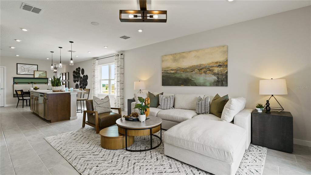 1353 June Lake Loop Haines City, FL 33844 - Photo 22 of 44 a living room with furniture and a chandelier