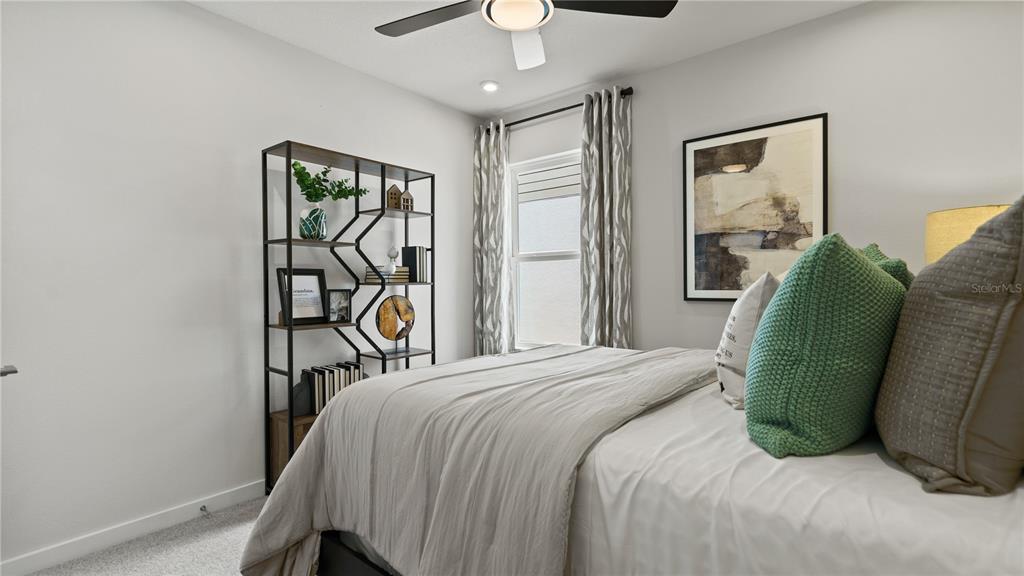 1353 June Lake Loop Haines City, FL 33844 - Photo 27 of 44 a bedroom with a bed and a chandelier