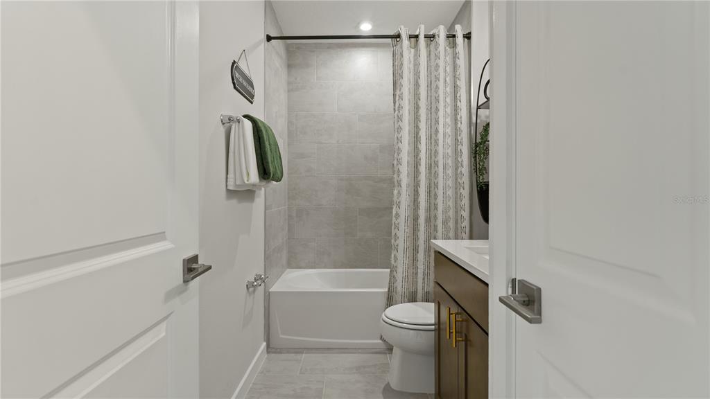 1353 June Lake Loop Haines City, FL 33844 - Photo 28 of 44 a bathroom with a shower a toilet and shower