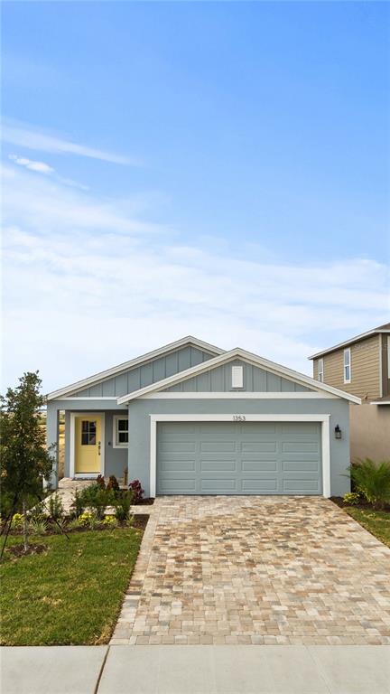 1353 June Lake Loop Haines City, FL 33844 - Photo 3 of 44 a front view of a house with a yard and garage