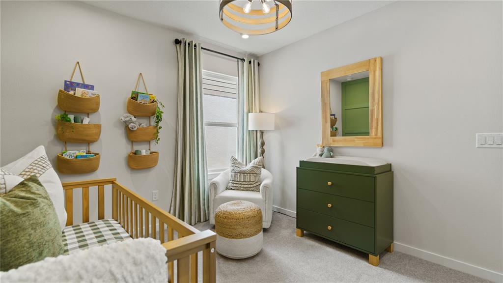 1353 June Lake Loop Haines City, FL 33844 - Photo 33 of 44 a bedroom with a bed and a chandelier