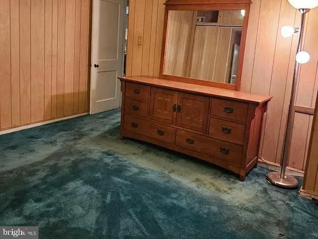 a view of a dresser with mirror in it