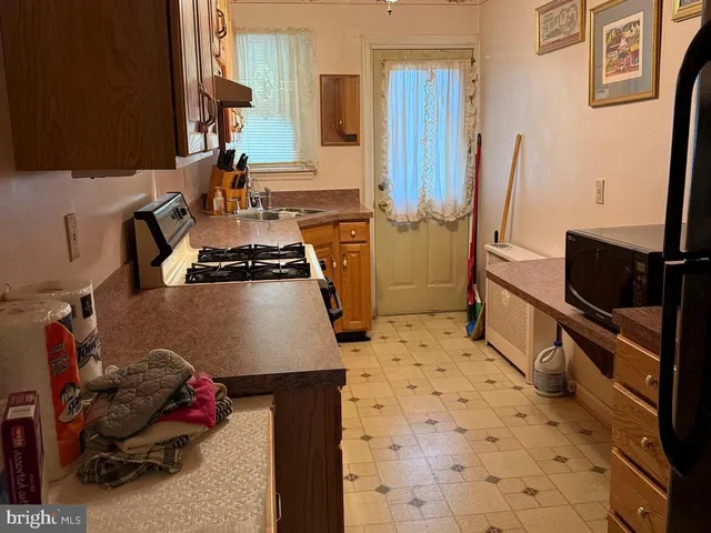 a kitchen with a sink appliances and cabinets