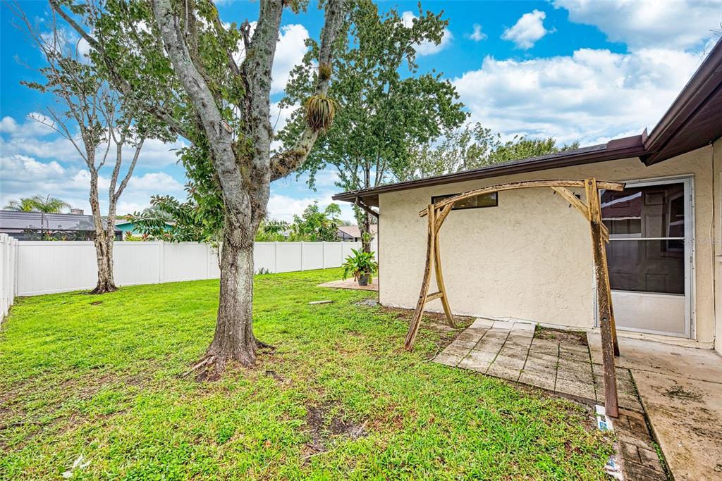 1330 Georgetowne Circle Sarasota, FL 34232 - Photo 36 of 46 a view of a backyard with a large tree