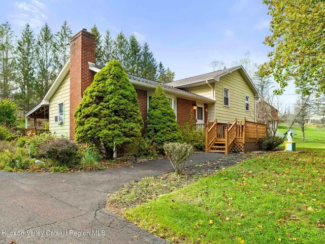 a view of a patio with table and chairs and potted plants