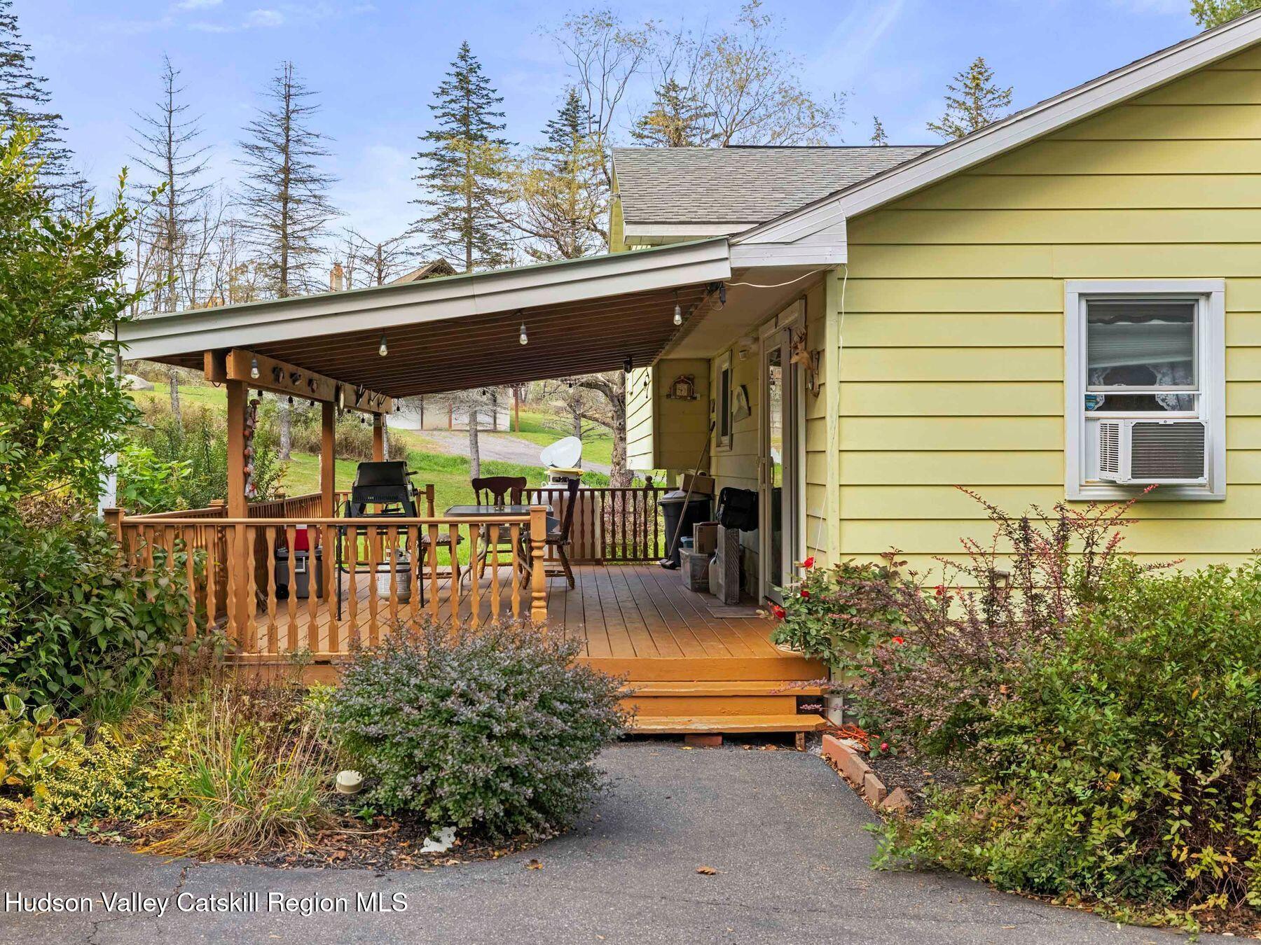 1339 Cornwallville Road Cornwallville, NY 12418 - Photo 15 of 47 a view of a patio with table and chairs potted plants and large tree