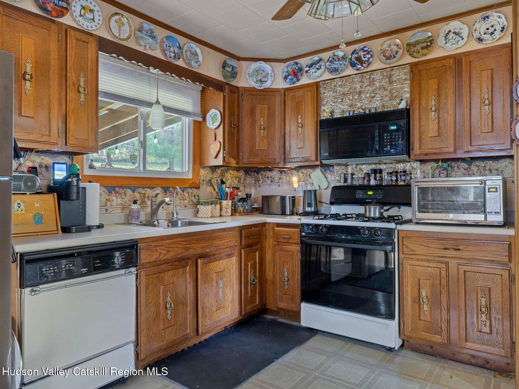 1339 Cornwallville Road Cornwallville, NY 12418 - Photo 21 of 47 a kitchen with stainless steel appliances granite countertop a stove a sink and a microwave