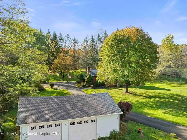 an aerial view of a house with a yard basket ball court and outdoor seating