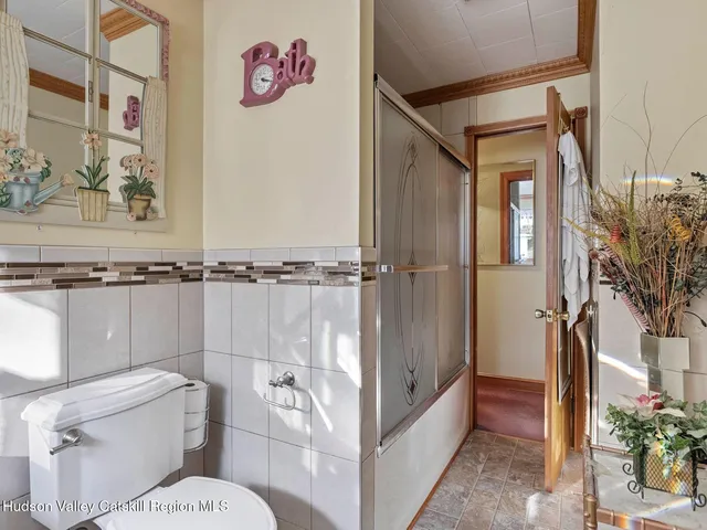 a bathroom with a granite countertop sink a large mirror and a window