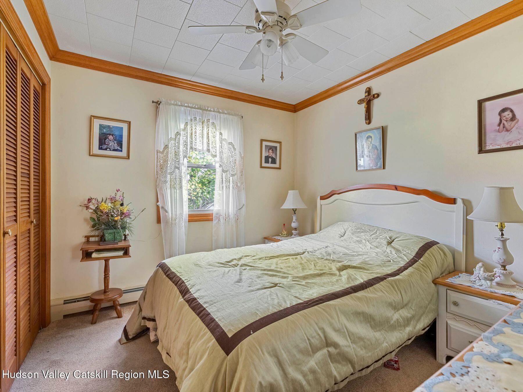 1339 Cornwallville Road Cornwallville, NY 12418 - Photo 34 of 47 a bedroom with a bed and a chandelier