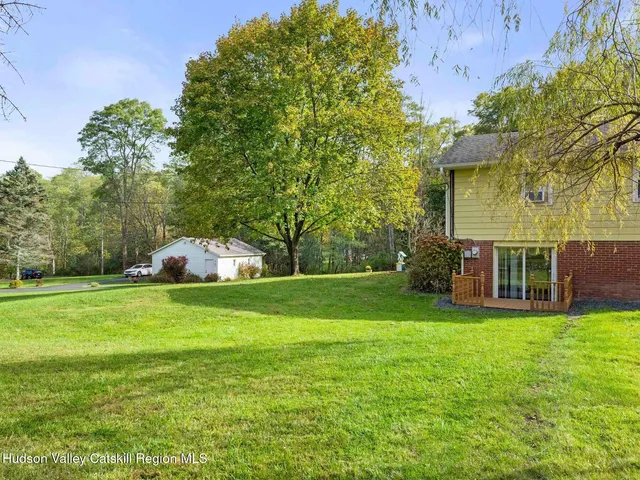 a view of a house with a yard balcony and sitting area