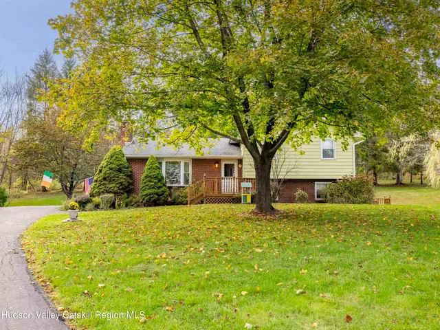 a view of an house with backyard space and garden