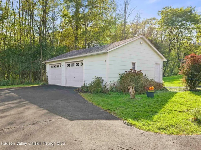 a green field with lots of trees in the background