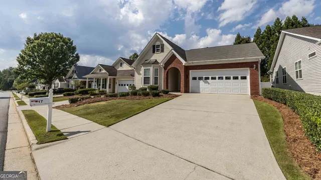 a front view of a house with a yard garage and outdoor seating