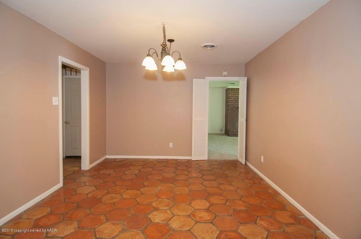 6016 Gainsborough Road Amarillo, TX 79106 - Photo 13 of 36 wooden floor in an empty room with a window