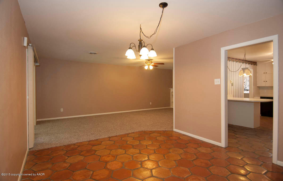 6016 Gainsborough Road Amarillo, TX 79106 - Photo 14 of 36 a view of a hallway with a chandelier