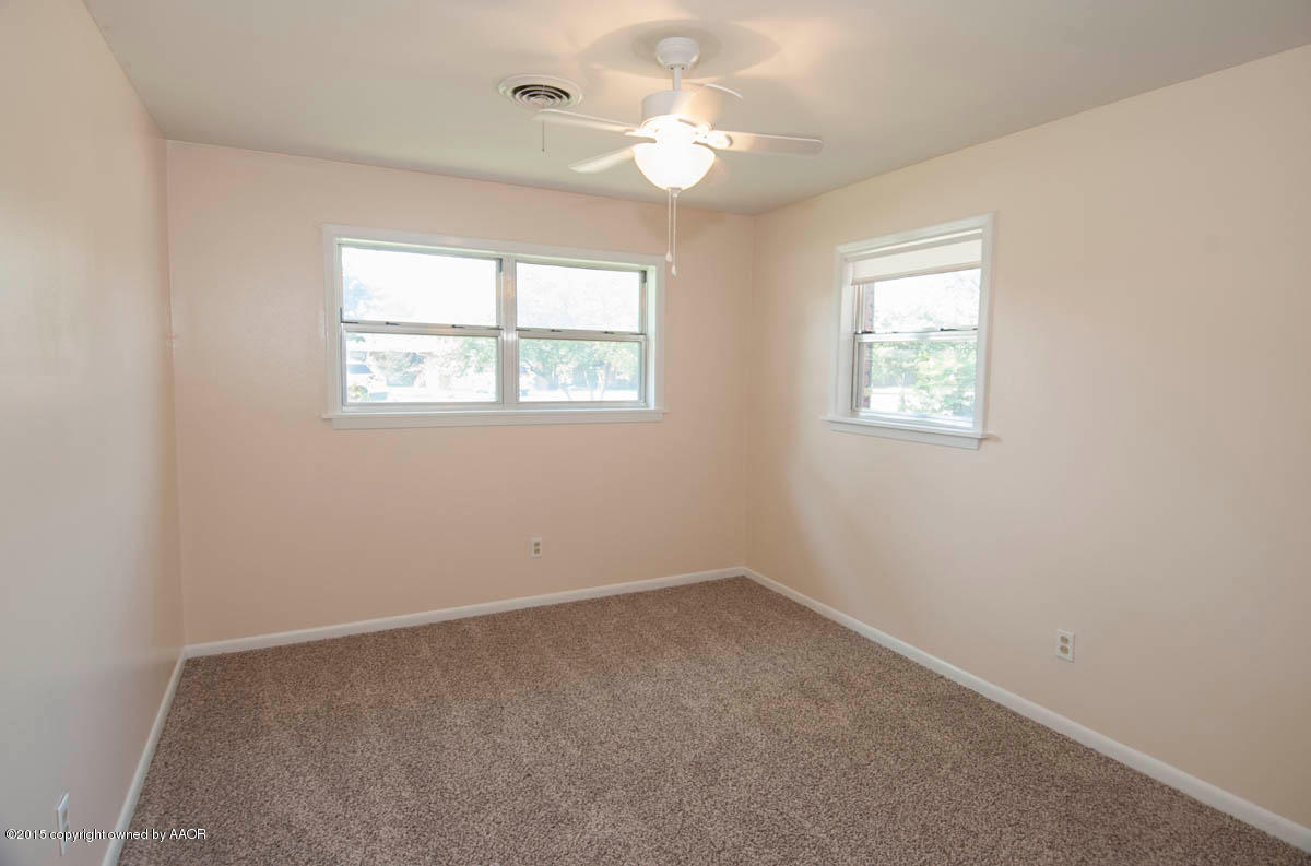 6016 Gainsborough Road Amarillo, TX 79106 - Photo 20 of 36 an empty room with a window and a fan