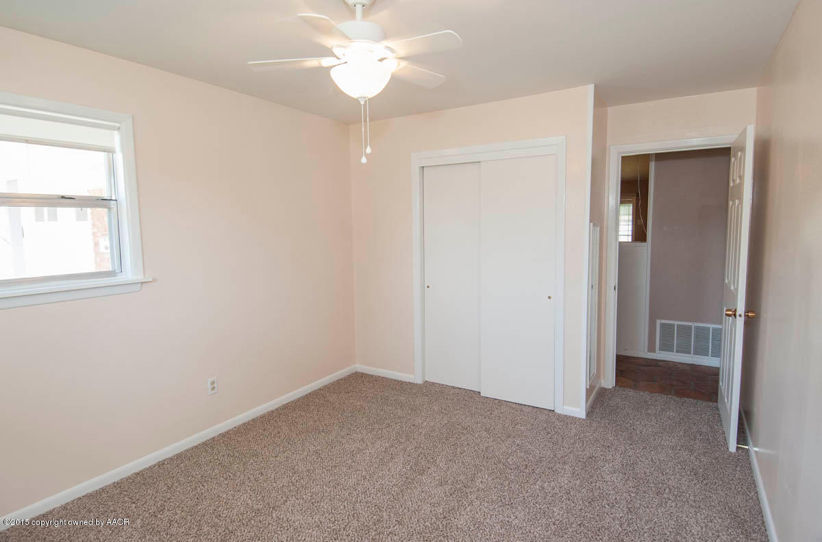 6016 Gainsborough Road Amarillo, TX 79106 - Photo 21 of 36 an empty room with a window and a chandelier fan