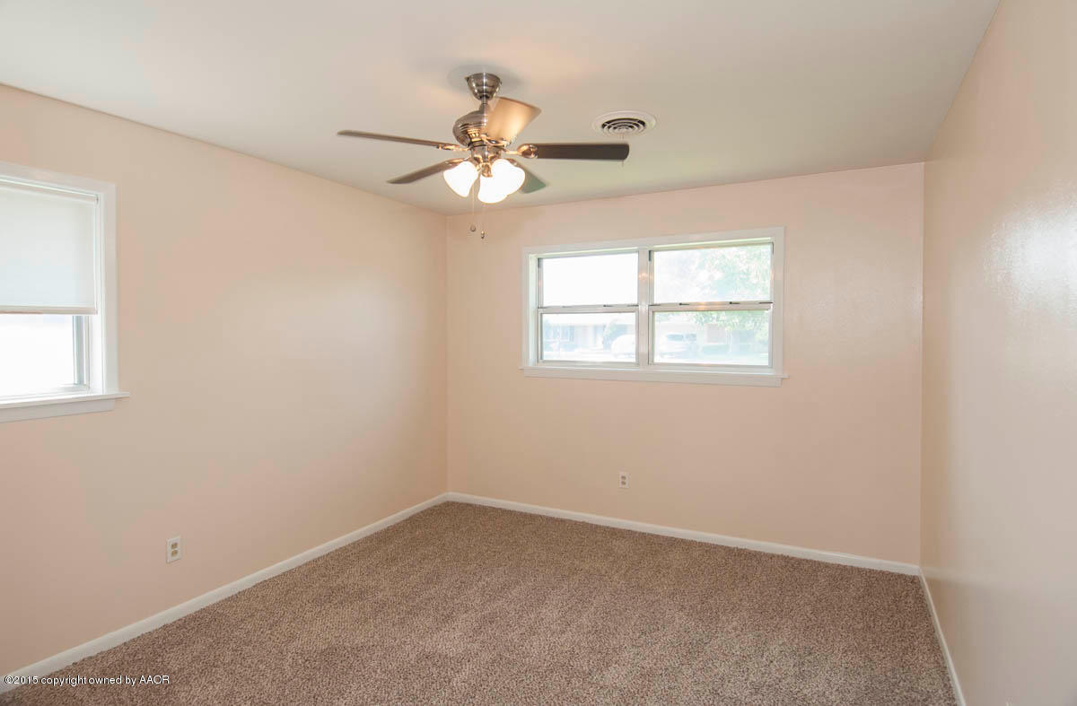 6016 Gainsborough Road Amarillo, TX 79106 - Photo 24 of 36 an empty room with windows and fan
