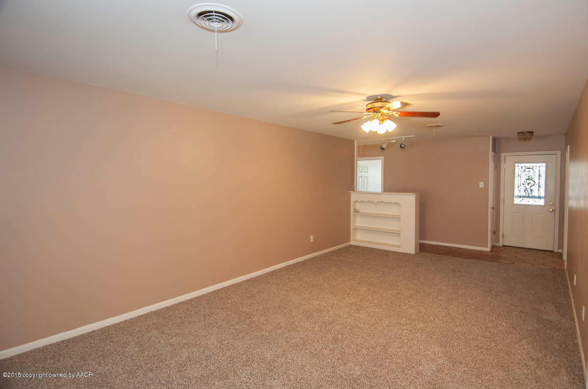 6016 Gainsborough Road Amarillo, TX 79106 - Photo 6 of 36 an empty room with windows and fan