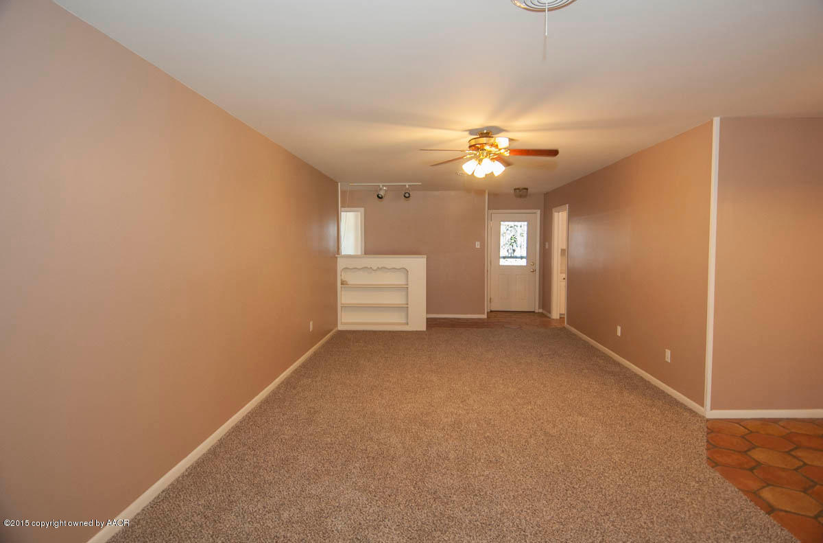 6016 Gainsborough Road Amarillo, TX 79106 - Photo 7 of 36 an empty room with chandelier fan and windows