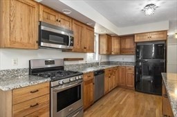 6 Mellen Street Hopedale, MA 01747 - Photo 3 of 42 a kitchen with stainless steel appliances granite countertop a stove top oven a sink dishwasher a refrigerator and a microwave oven