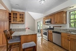 6 Mellen Street Hopedale, MA 01747 - Photo 4 of 42 a kitchen with stainless steel appliances granite countertop a stove top oven a sink dishwasher and wooden cabinets with wooden floor