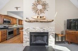 6 Mellen Street Hopedale, MA 01747 - Photo 10 of 42 a living room with furniture a fireplace and a flat screen tv