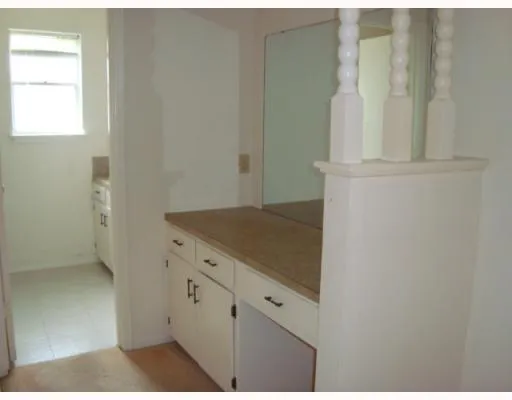 a view of a kitchen with white cabinets