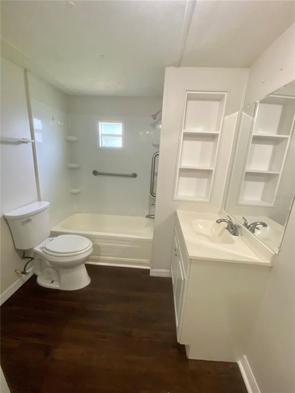 38313 Tucker Road, Unit 3 Zephyrhills, FL 33542 - Photo 13 of 20 a bathroom with a sink a toilet and shower