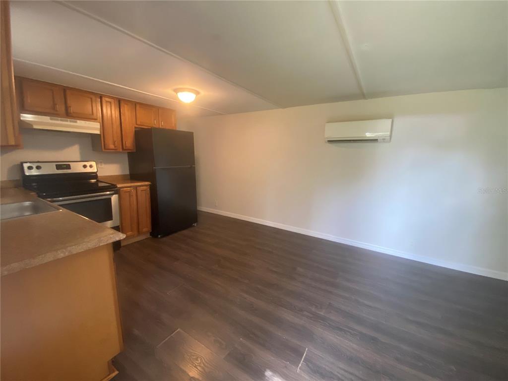 38313 Tucker Road, Unit 3 Zephyrhills, FL 33542 - Photo 4 of 20 a view of a kitchen with wooden floor