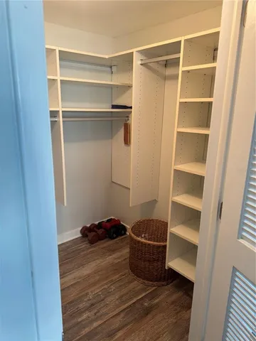 a view of walk in closet with empty racks