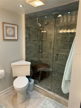 a bathroom with a toilet and a shower