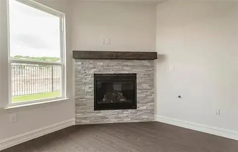 a living room with a fireplace and a floor to ceiling window